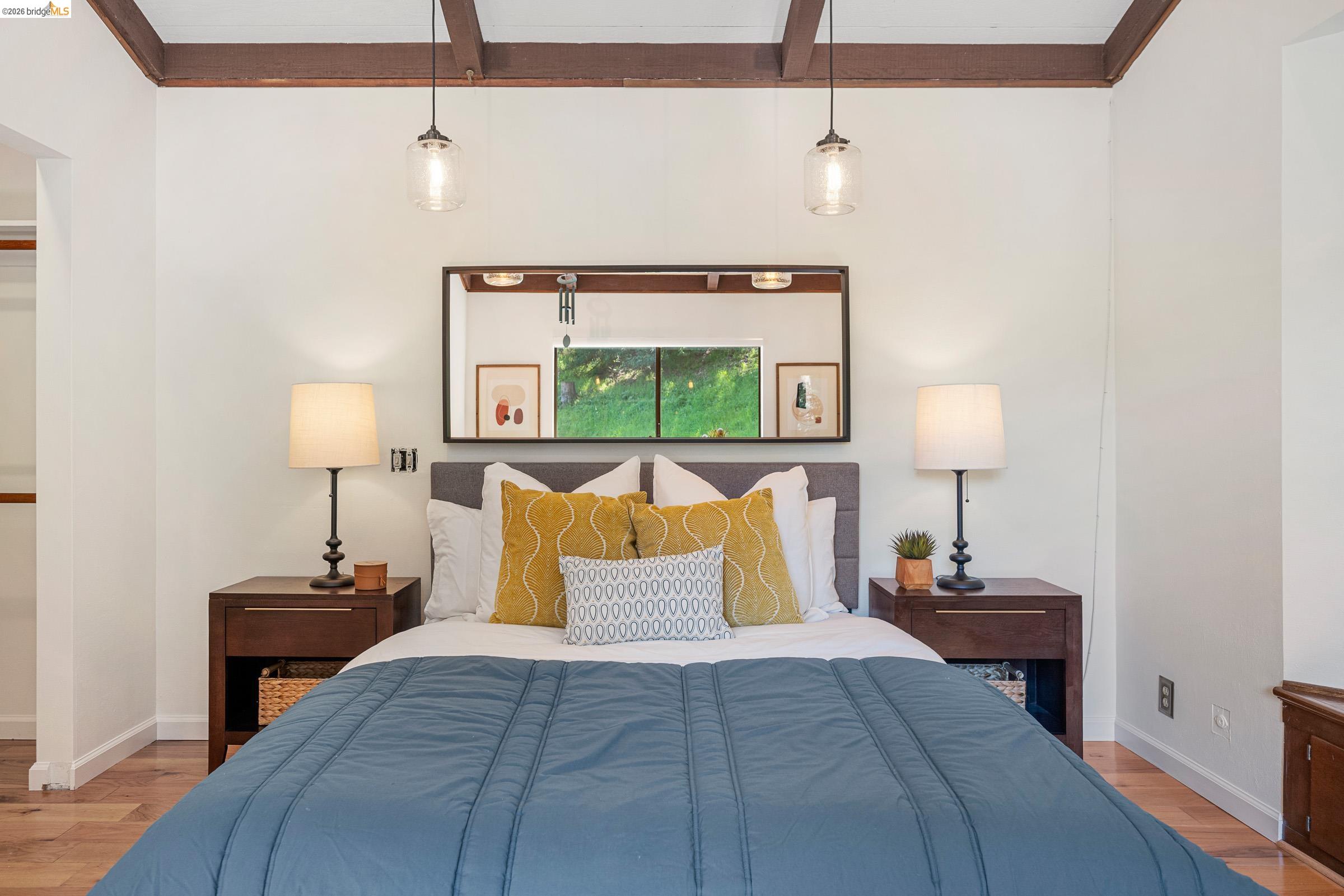 6600 Heather Ridge Way Oakland, CA 94611 - Photo 39 of 66 Exposed wood ceiling beams accentuating the white ceiling, complemented by wood-finish flooring