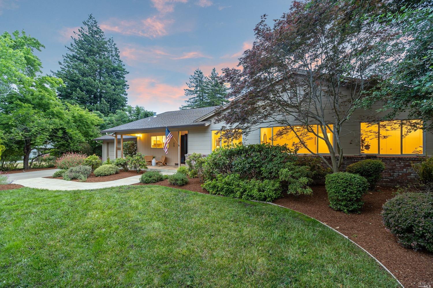 a front view of house with yard and green space