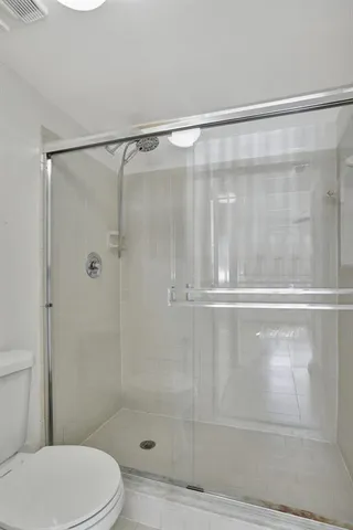 a bathroom with a shower and a toilet