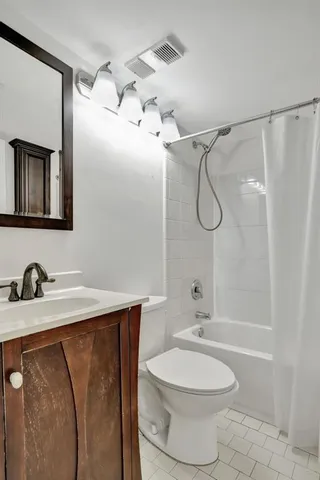 a bathroom with a granite countertop sink toilet a shower and a mirror