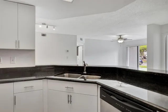 a kitchen with a sink and cabinets