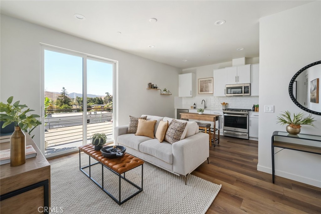 2355 Victoria Avenue, Unit 304 San Luis Obispo, CA 93401 - Photo 1 of 16 a living room with furniture and a fireplace