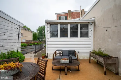 a front view of a house with a yard and outdoor seating