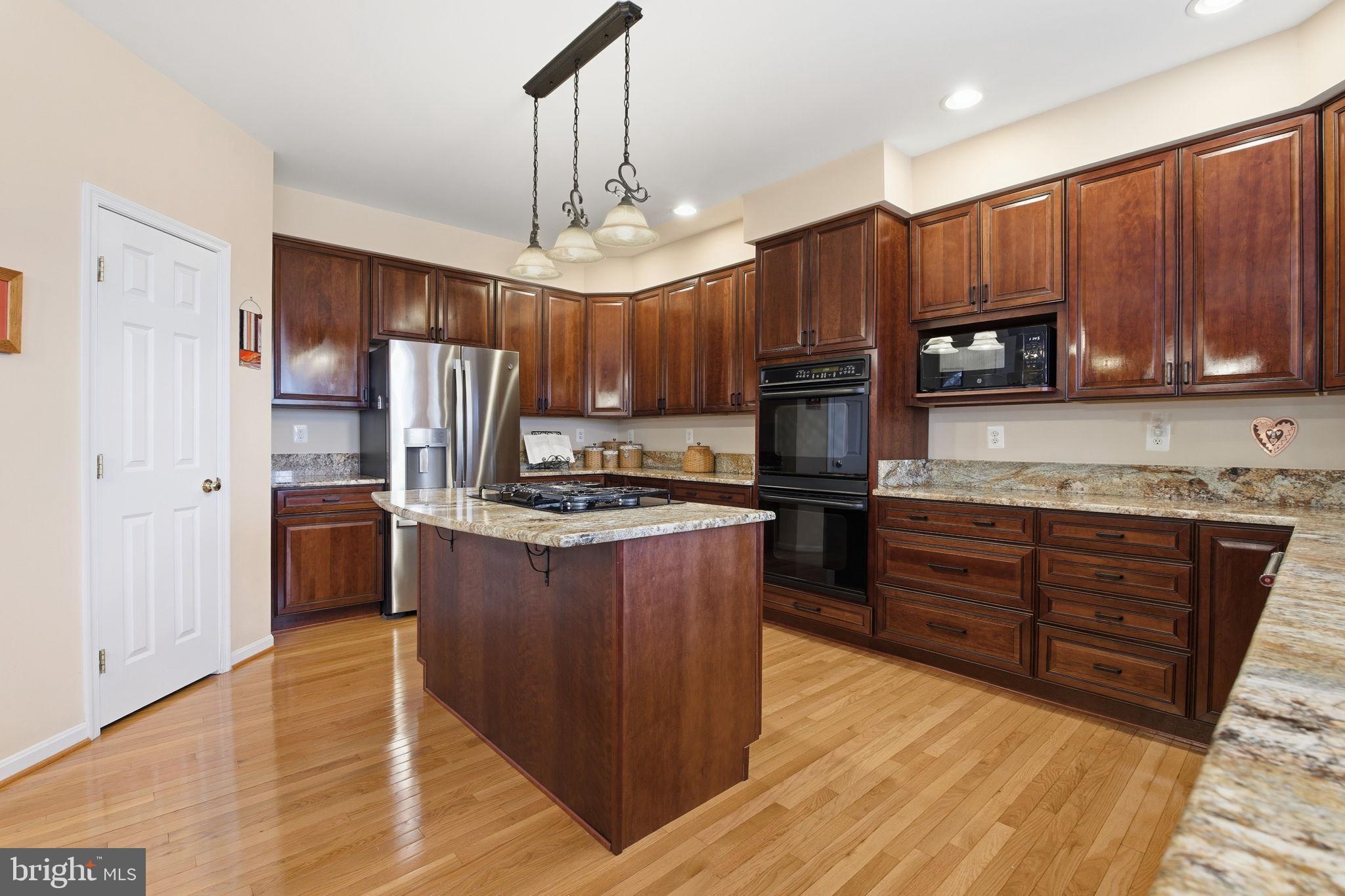 5534 Nutwell Sudley Road Deale, MD 20751 - Photo 8 of 58 Elegant kitchen with rich wood cabinetry.