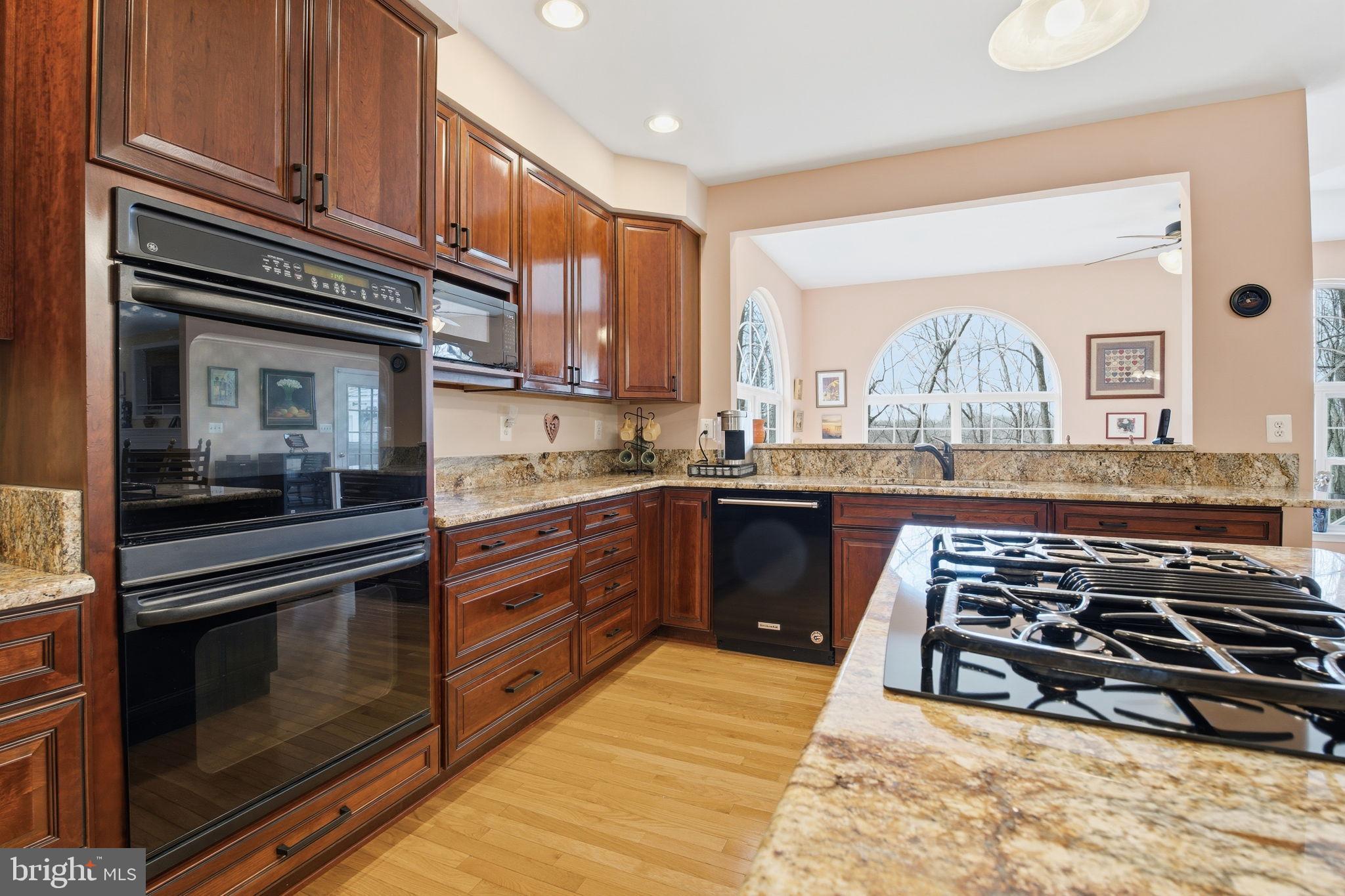 5534 Nutwell Sudley Road Deale, MD 20751 - Photo 10 of 58 Elegant kitchen with rich wood cabinetry.
