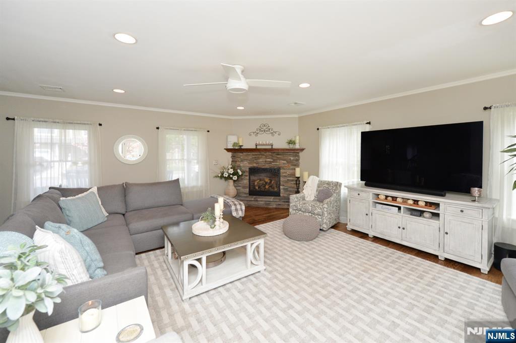 6 Long Avenue Mahwah, NJ 07430 - Photo 11 of 49 a living room with furniture a flat screen tv and a fireplace