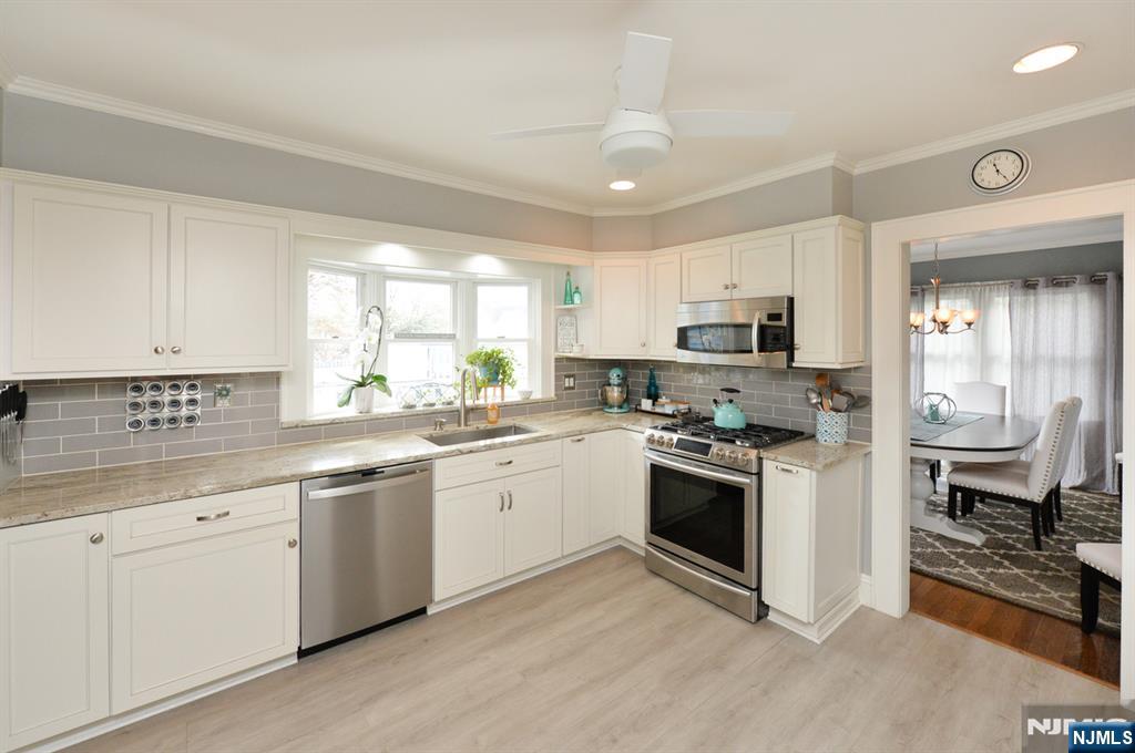 6 Long Avenue Mahwah, NJ 07430 - Photo 18 of 49 a kitchen with granite countertop white cabinets and white appliances