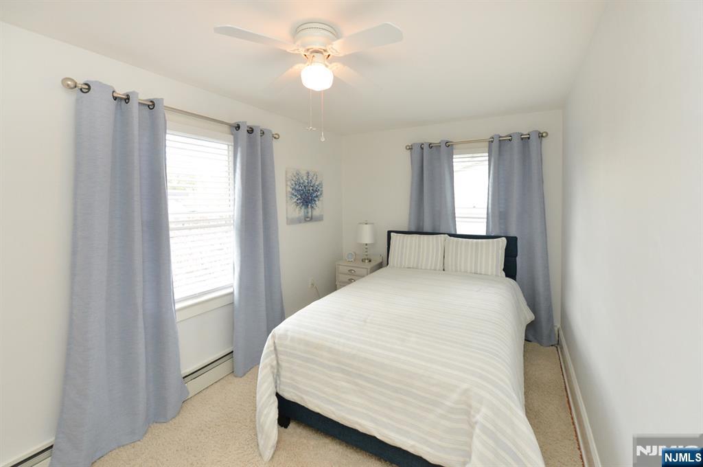 6 Long Avenue Mahwah, NJ 07430 - Photo 26 of 49 a bedroom with a large bed and a chandelier