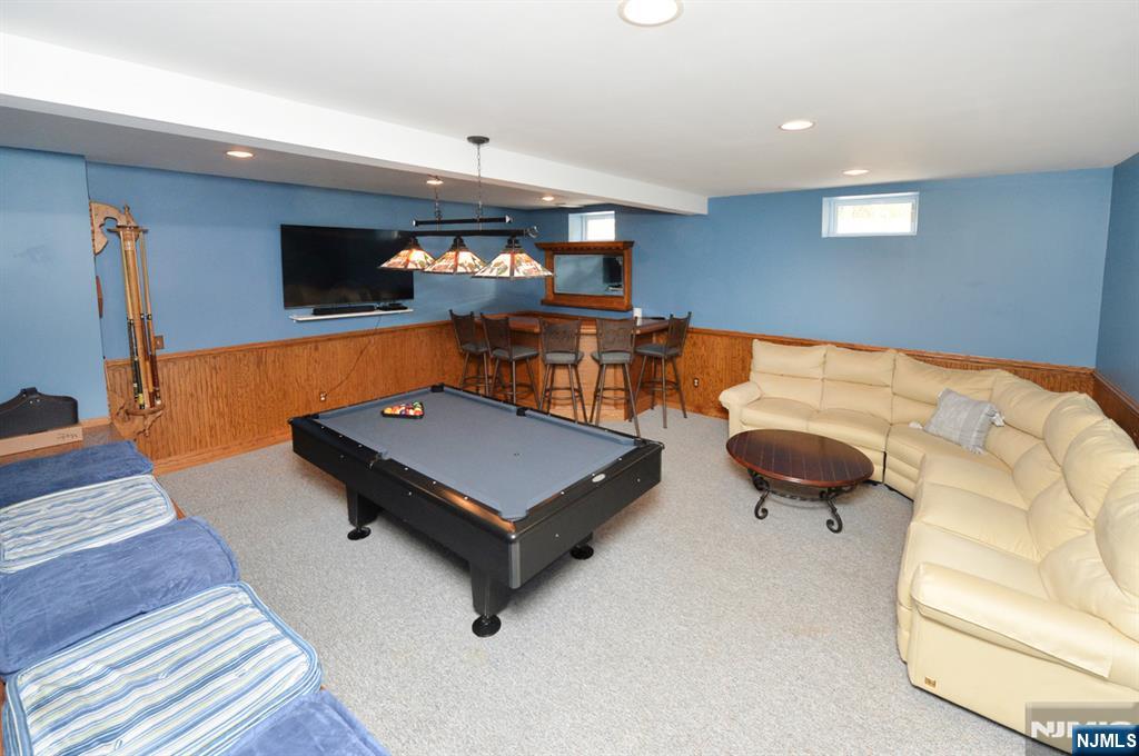 6 Long Avenue Mahwah, NJ 07430 - Photo 37 of 49 a living room with furniture pool and a flat screen tv