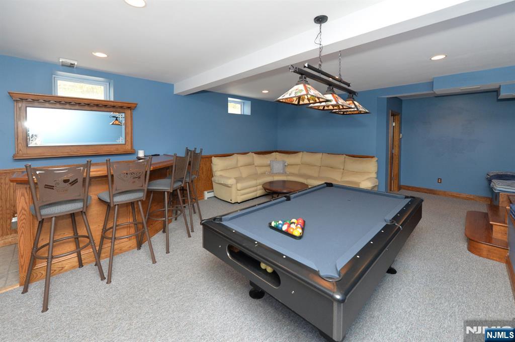 6 Long Avenue Mahwah, NJ 07430 - Photo 38 of 49 a living room with furniture and a flat screen tv