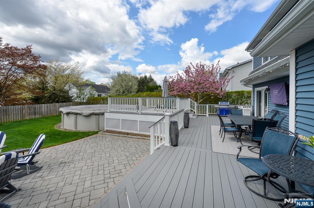 6 Long Avenue Mahwah, NJ 07430 - Photo 46 of 49 a view of a patio with dining table and chairs with a swing