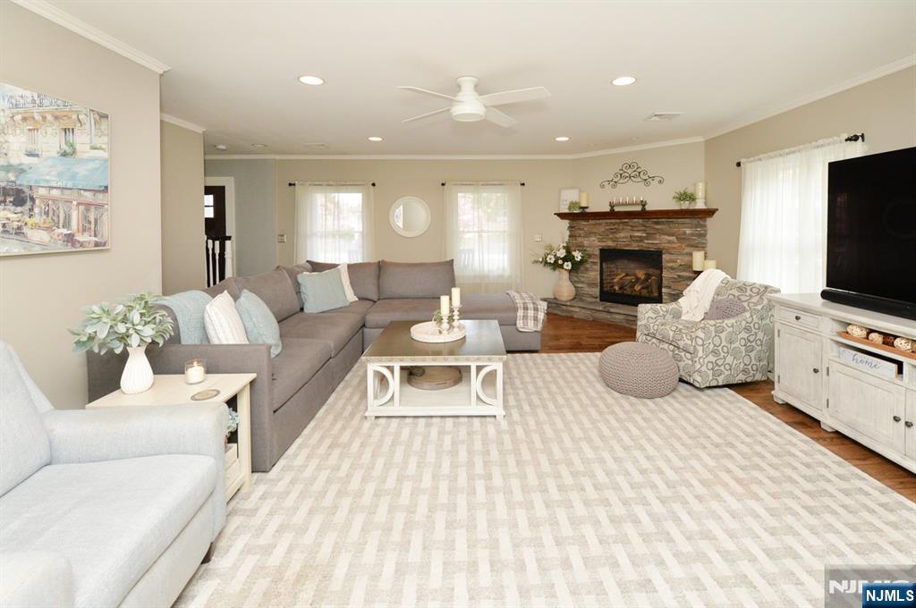 6 Long Avenue Mahwah, NJ 07430 - Photo 10 of 49 a living room with furniture a flat screen tv and a fireplace