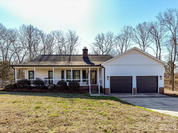 a view of a house with wooden fence