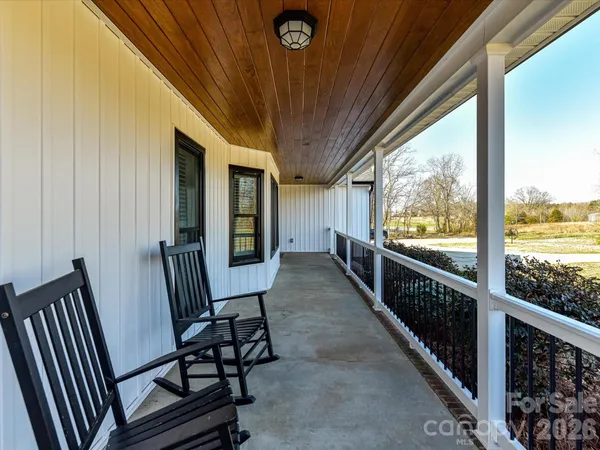a view of a balcony with wooden floor and stairs