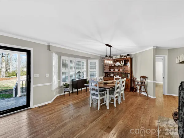 a dining room with furniture a chandelier and window