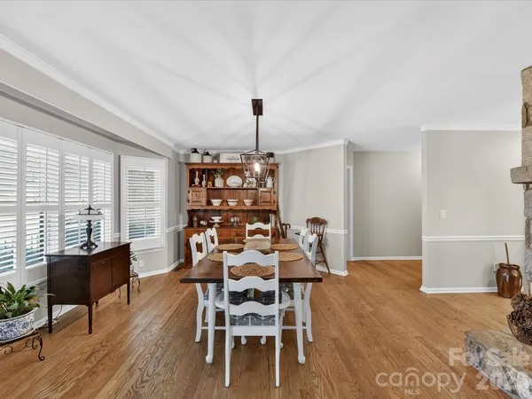a dining room with furniture and wooden floor