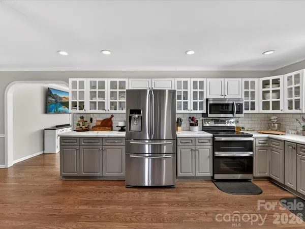 a kitchen with stainless steel appliances a refrigerator and a stove top oven