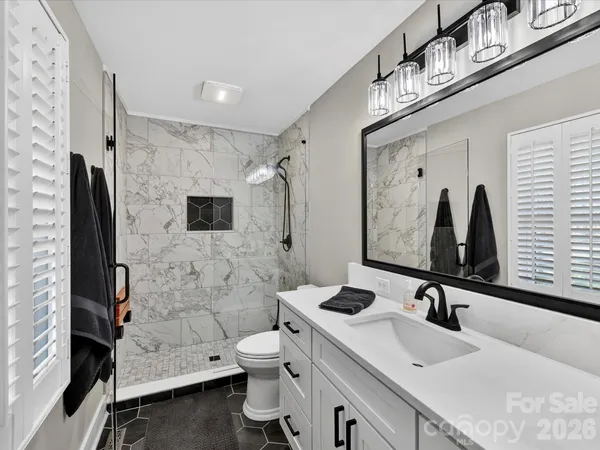 a bedroom with bed and a window