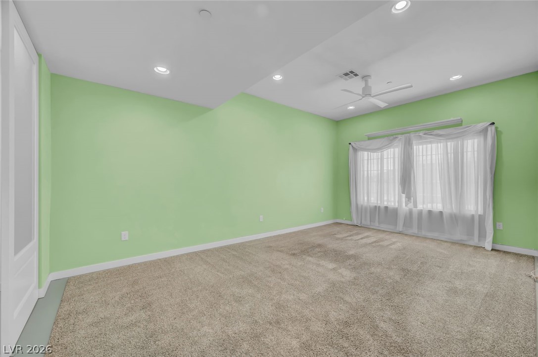 640 North Racetrack Road Henderson, NV 89015 - Photo 52 of 65 Well-lit living area featuring soft carpet, recessed lighting, and a prominent window.