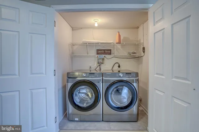a view of washer and dryer with kitchen in the background