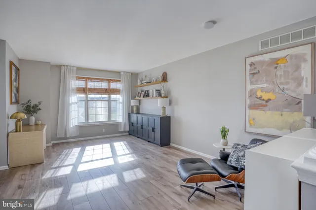 a living room with furniture and next to a window