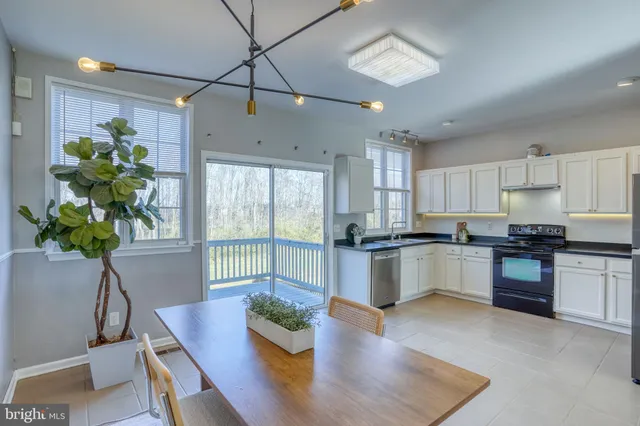 a kitchen with furniture and a potted plant