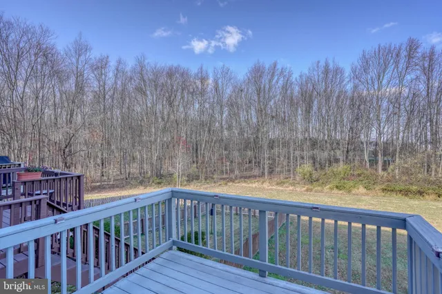 a view of balcony with wooden floor and fence
