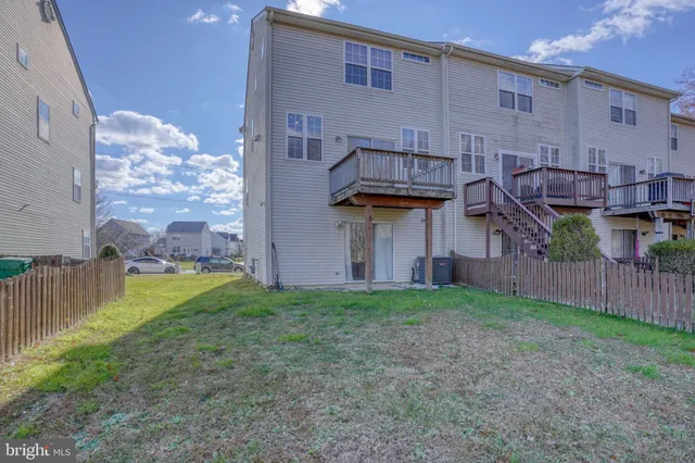 a view of a house with wooden fence