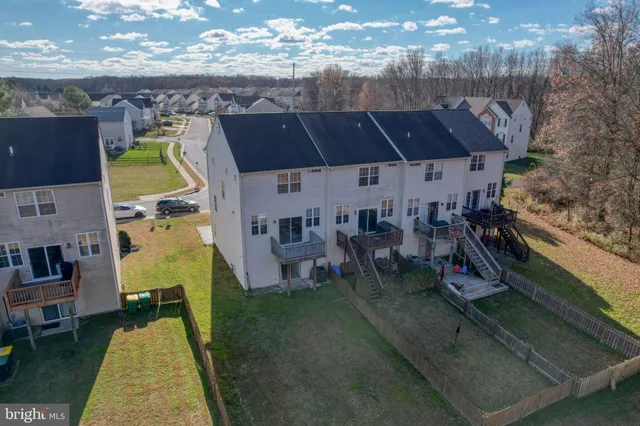 an aerial view of a house with swimming pool and sitting space