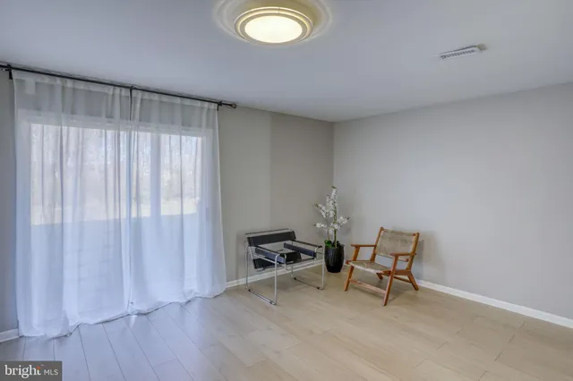 a view of a room with wooden floor and furniture
