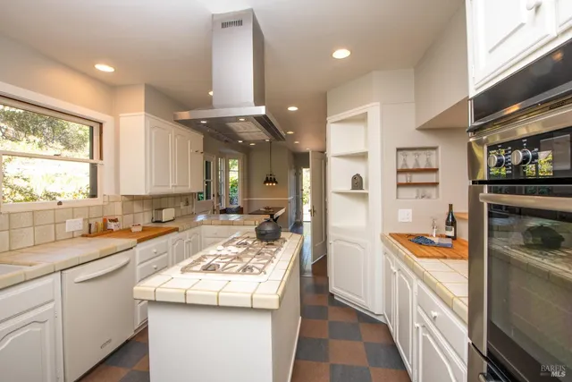 a kitchen with sink and refrigerator