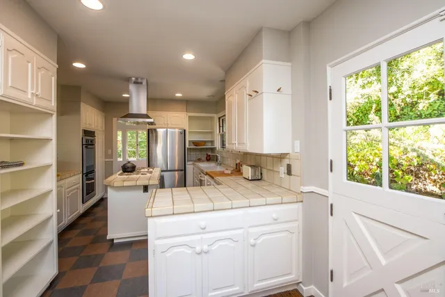 a living room with kitchen island furniture and a large window