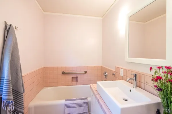 a bathroom with a sink a toilet a shower and a mirror