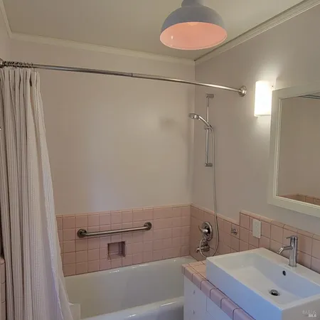 a spacious bathroom with a granite countertop sink and a mirror