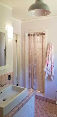 a bathroom with a glass shower door