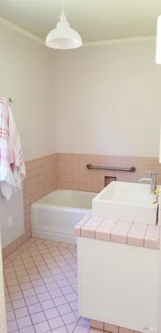 a kitchen with a sink and a stove top oven