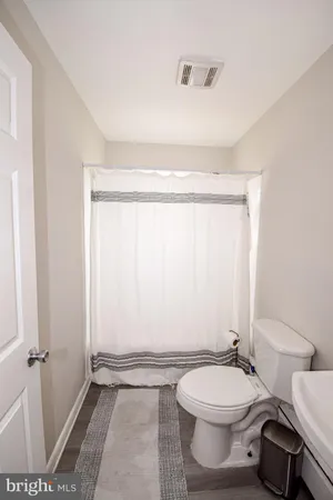 a bathroom with a toilet a sink and a window