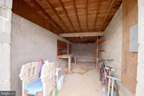 a view of swimming pool with outdoor seating and covered with trees in the background