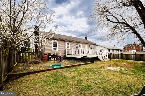a view of a house with a big yard and a large tree