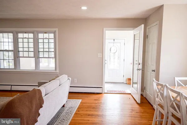 a hallway with wooden floor and windows