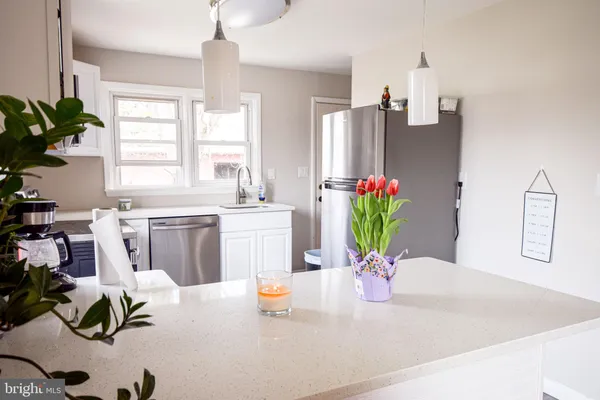 a kitchen with a refrigerator and a sink