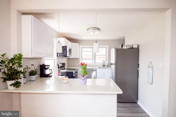 a kitchen with a refrigerator stove and sink