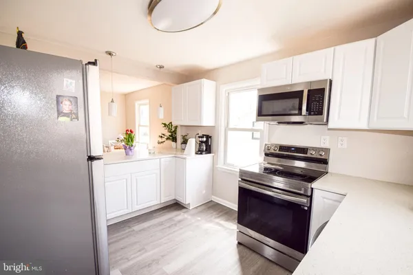a large white kitchen with cabinets