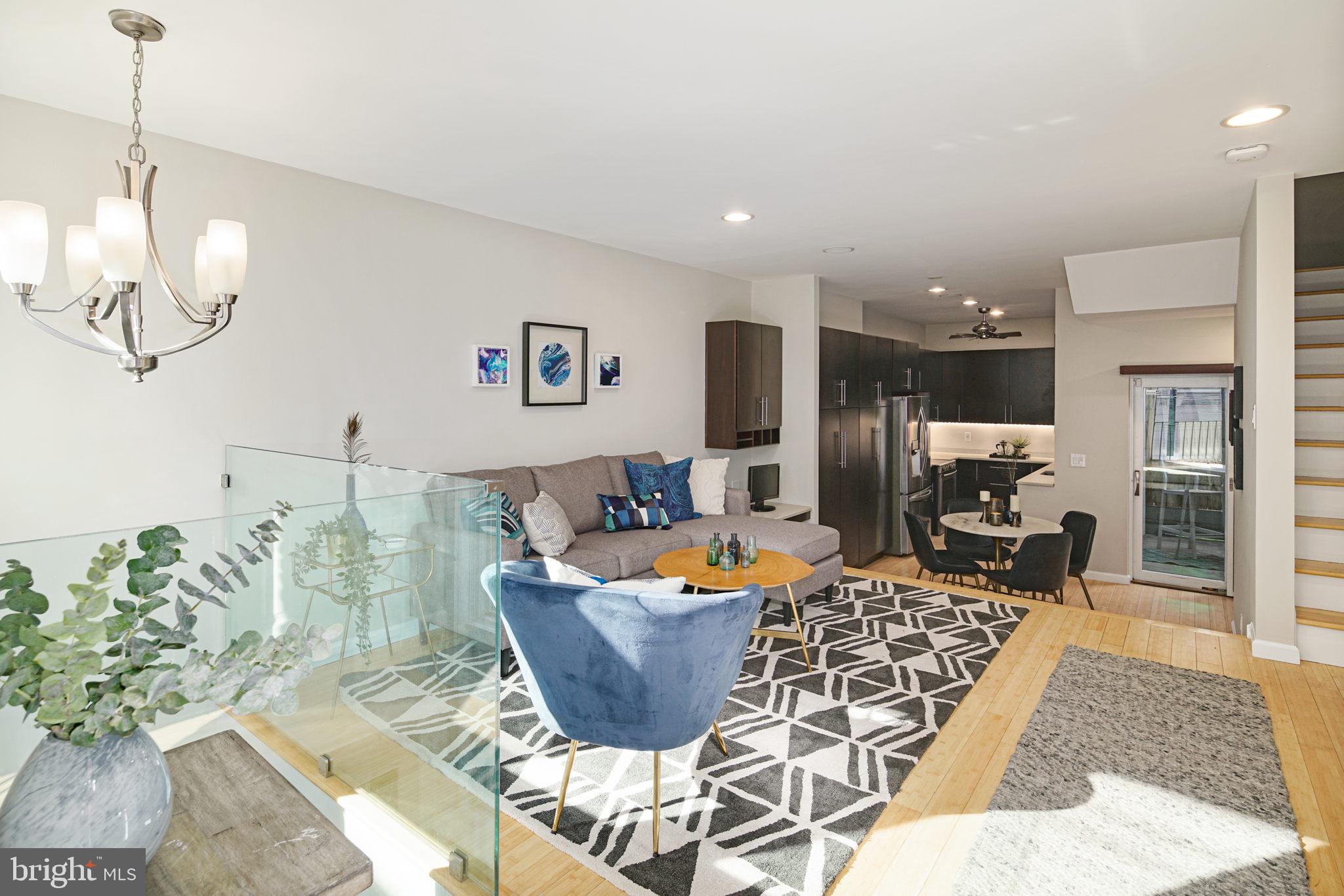 a living room with patio furniture and a chandelier