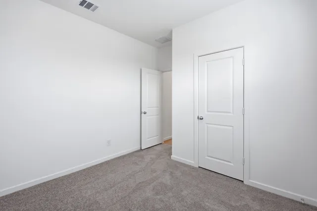 an empty room with closet area