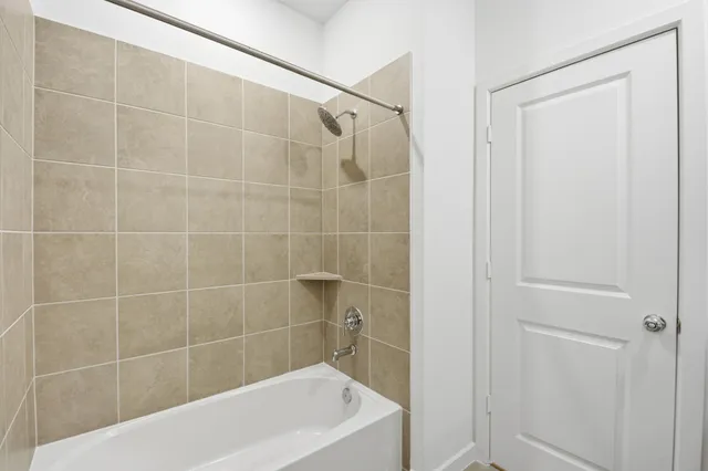 a bath tub sitting next to a white sink and a shower