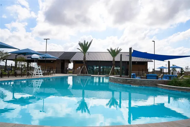 a view of a swimming pool with a table and chairs