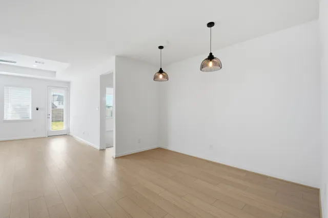 a view of a room with wooden floor and windows