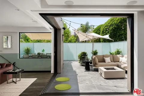 a patio with patio a table and chairs under an umbrella