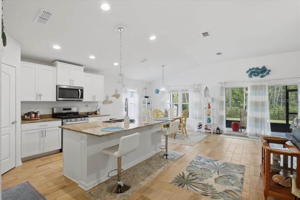 35 Birdie Way Bunnell, FL 32110 - Photo 6 of 57 a large white kitchen with lots of counter space and stainless steel appliances
